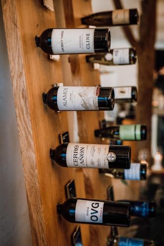 a bunch of wine bottles on a wooden wall at HOT_elarnia Hotel & Spa in Puszczykowo