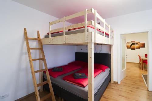 a bedroom with two bunk beds and a ladder at CozyNite Premium Apartment Schönbrunn 1 in Vienna
