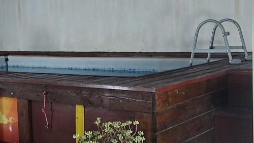 a swimming pool with a brick wall at La Dolce Oasi in Triscina