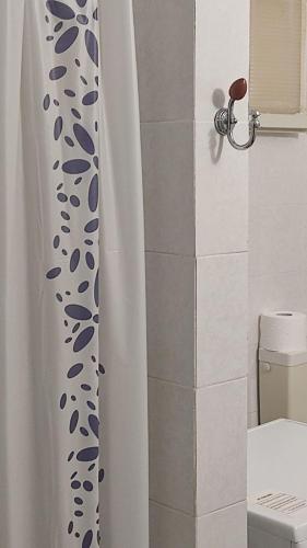 a shower curtain in a bathroom with a toilet at La Dolce Oasi in Triscina