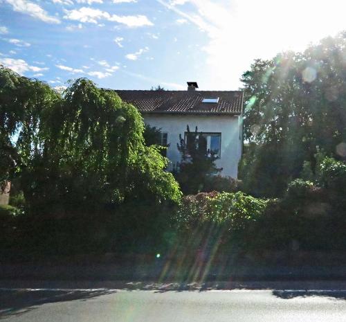 a house in the middle of a field with trees at Ferien-Messe-Handwerker- Apartment Bensberg in Bergisch Gladbach