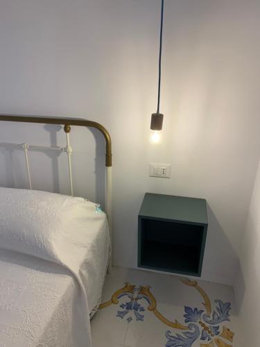 a bedroom with a bed and a small television at Solis Domus Oriens in Ostuni