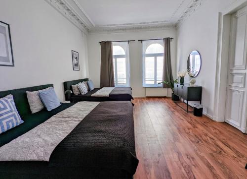 a living room with a large bed and a couch at Leipzig Residenz City-Center Apartments in Leipzig