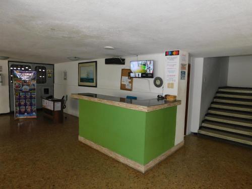 a lobby with a green counter in a room at El Velero Apartamentos By DANP in Santa Marta