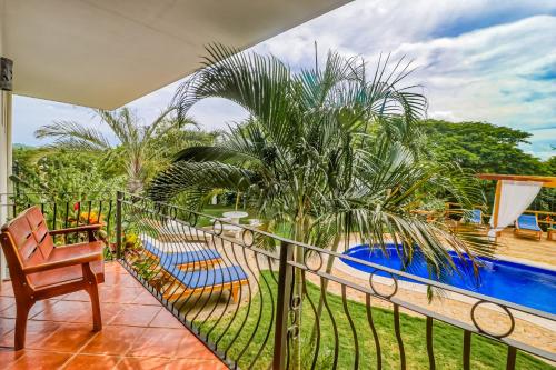 a balcony with a view of a swimming pool at Casa Mimosa in Playa Flamingo