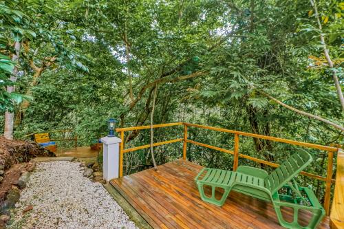 a wooden deck with a green chair sitting on it at Casa Mimosa in Playa Flamingo