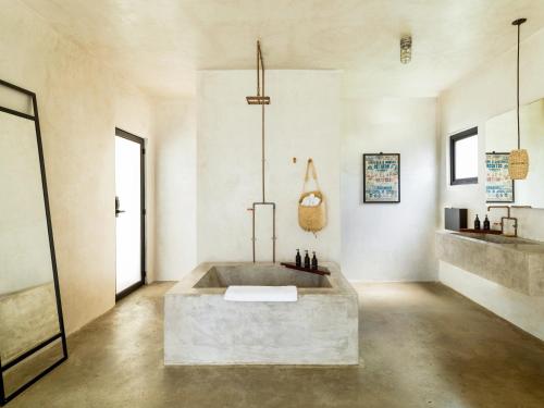 a large bathroom with a large tub in a room at Drift San Jose del Cabo, a Member of Design Hotels in San Jos&eacute; del Cabo
