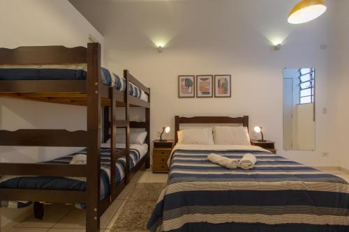 a bedroom with a bunk bed and two bunk beds at BH Studios Hotel Brás in Sao Paulo