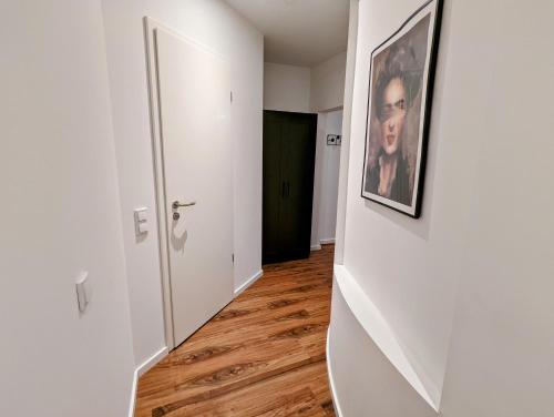 an empty hallway with a picture of a man on the wall at Leipzig Residenz City-Center Apartments in Leipzig