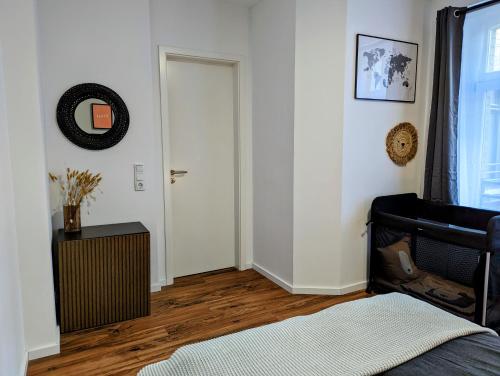 a room with a bed and a door and a table at Leipzig Residenz City-Center Apartments in Leipzig