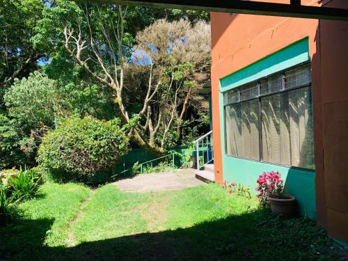 a house with a window on the side of it at Globi Lodge #3 in Monteverde Costa Rica