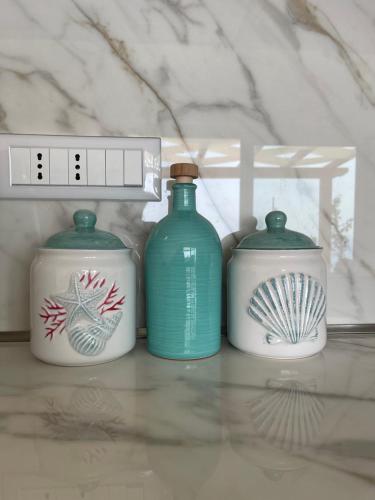 three blue and white bottles sitting on a shelf at Villa Sofia *Luxury experience in Calabria in Zambrone