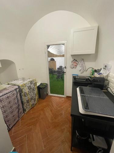 a room with a kitchen with a table and a counter top at Holiday Home NomiS in Maratea