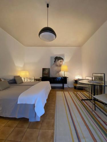 a bedroom with a bed and a table and a couch at Casa Antonio Noto in Noto