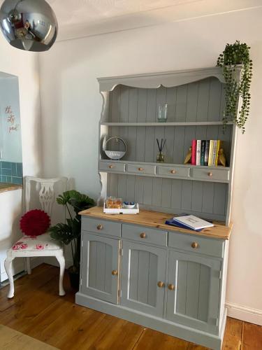 a gray hutch with a book shelf in a room at The City Pad in Norwich