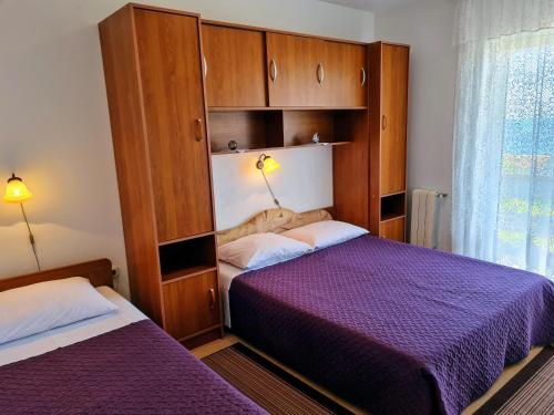 1 dormitorio con 2 camas y armarios de madera en Angel en Lun