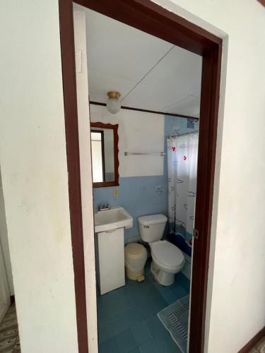 a bathroom with a toilet and a sink at Hotel Sierpe River- Oleaje Sereno in Sierpe