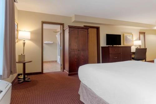 a hotel room with a bed and a television at Best Western Plus Fredericton Hotel & Suites in Fredericton