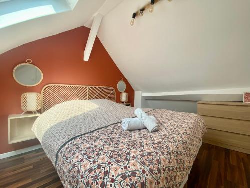 a bedroom with a bed with a stuffed animal on it at Magnifique duplex pour huit personnes -070 in Rouen