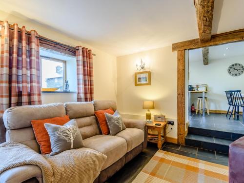 a living room with a couch and a table at The Stables in Llanfair Caereinion
