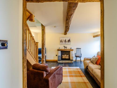 a living room with a couch and a fireplace at The Stables in Llanfair Caereinion