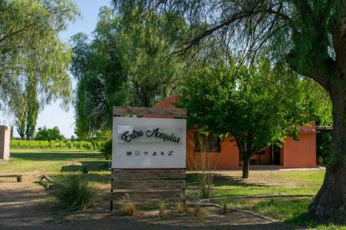 a sign in a park in front of a building at Entre Acequias in General Alvear