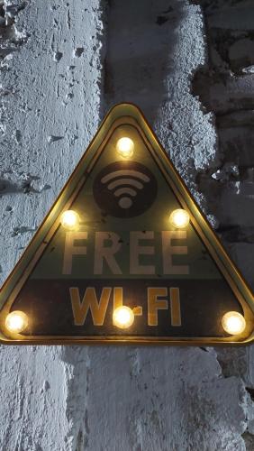 a sign that says free wifi on a street at JUMANA in Nazca