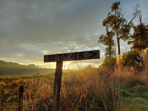 a sign that says forever in a field at DuxHouse BnB in Taihape