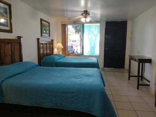 a hotel room with two beds and a window at Freedom Shores "La Gringa" Hotel - Universally Designed in Isla Aguada