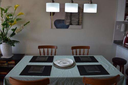 a dining room table with a blue table cloth and chairs at VIVE LA EXPERIENCIA, PLAYA, SPA, CASINO DE JUEGOS in Coquimbo