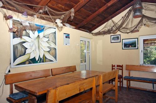 a dining room with a wooden table and a painting on the wall at Apartments by the sea Cove Saplunara, Mljet - 4914 in Saplunara