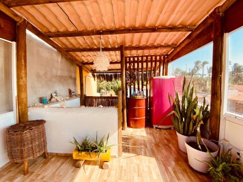 a bathroom with a tub and a sink and some plants at Casa Di Dóres in Trairi