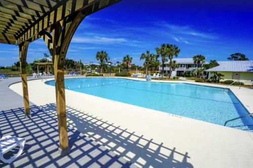a swimming pool at a resort at St Helena Island Retreat with Deck Walk to Beach in Oceanmarsh Subdivision