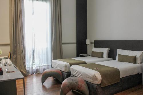 a hotel room with two beds and a large window at Esplendor by Wyndham Savoy Rosario in Rosario