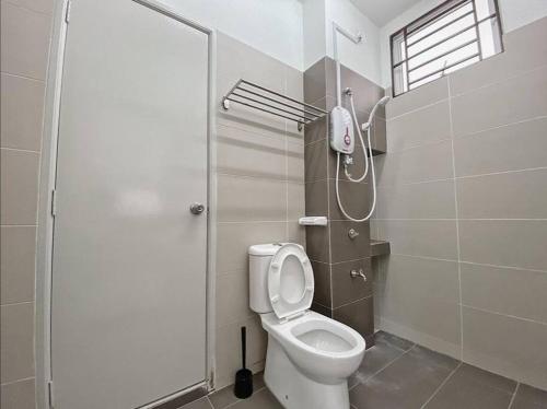 a bathroom with a toilet and a shower at Desaru M'Cozy/12pax/Mini Pool/ Waterpark/BBQ/WIFI in Bandar Penawar