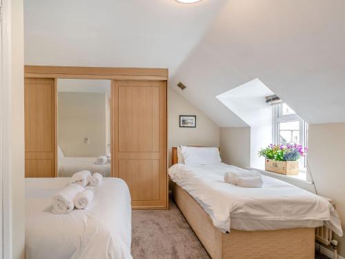 a bedroom with two beds and a mirror at Platform 5 & 34 in Pickering