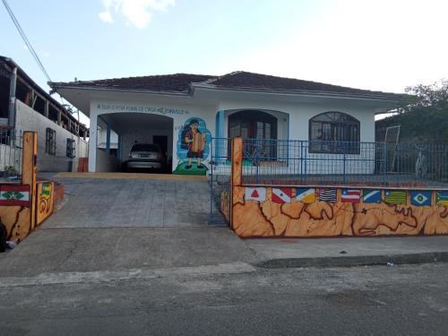 a house with a fence in front of it at Hostel e Pousada Boa Vista in Joinville