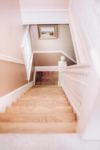 a staircase in a home with wooden floors at Benn Conger Inn in Groton