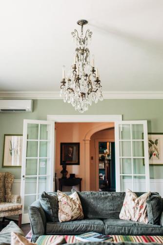 a living room with a couch and a chandelier at Benn Conger Inn in Groton