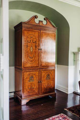 a wooden cabinet in a room with a wall at Benn Conger Inn in Groton