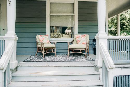 two chairs and a table on the front porch of a house at Benn Conger Inn in Groton