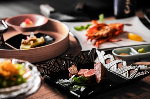 a table with a plate of food on a table at Garden Terrace Saga Hotel & Resorts in Saga