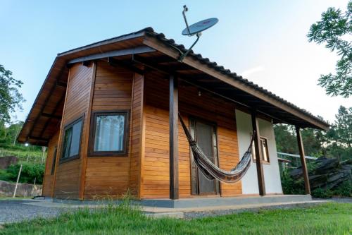 a small house with a hammock on the roof at Hospedagem Rural Fazenda Sacramento in Rodeio Doze