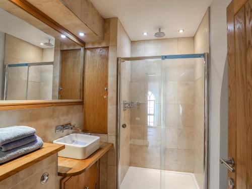 a bathroom with a shower and a sink at Capel Tabernacl in Pwllheli