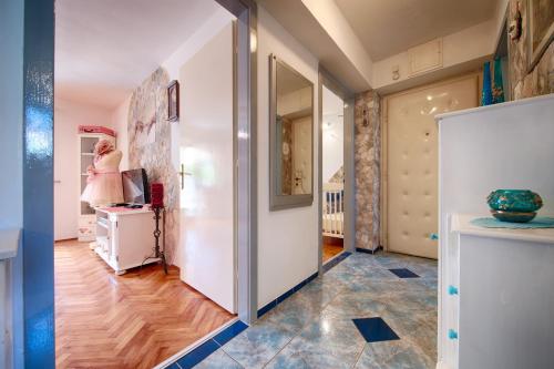 a hallway with a woman standing in a room at Apartments by the sea Komiza, Vis - 8860 in Komiža