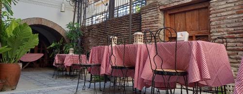 a group of tables with pink blankets on them at RF ANICETO MANSION in Vigan