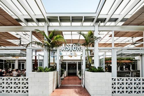 arium of a building with palm trees in it at Astor Hotel Motel in Albury