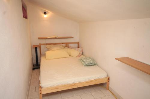 a small bedroom with a bed in a room at Apartment Rukavac 8864b in Rukavac