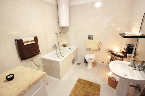 a bathroom with a tub and a toilet and a sink at Apartments with a parking space Split - 8681 in Split