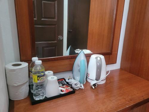 a bathroom counter with a sink and a mirror at Deluxe Room in Pendang